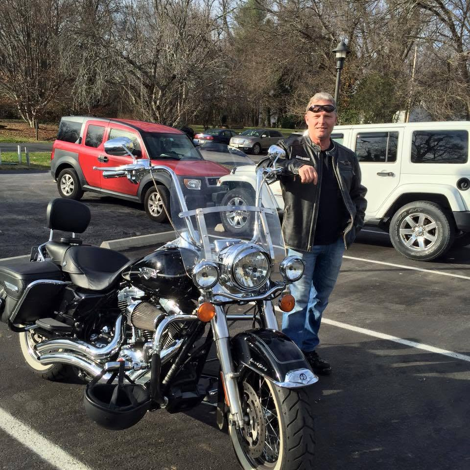 Michael Agee standing beside his Harley-Davidson motorcycle in Northern Virginia.